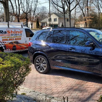 BMW X5 on a paver driveway, Rashine trailer at the curb