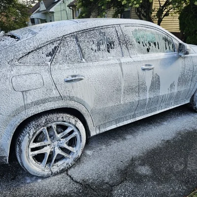 A Mercedes-Benz GLE Coupe under a full covering of snow foam