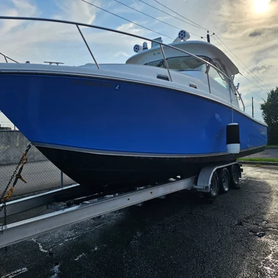 The bow of a blue sportfishing boat up on its trailer