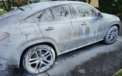 A Mercedes-Benz GLE Coupe under a full covering of snow foam